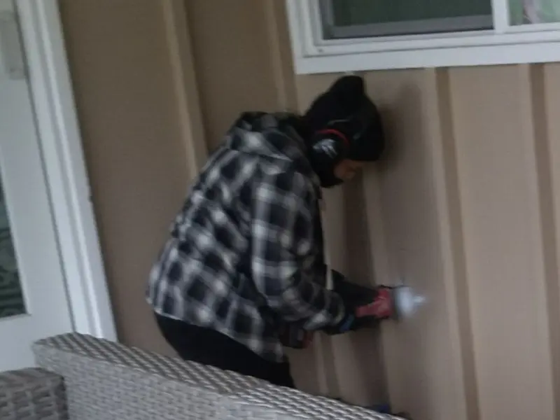 Professional electrician installing an exterior outlet in Wrightstown